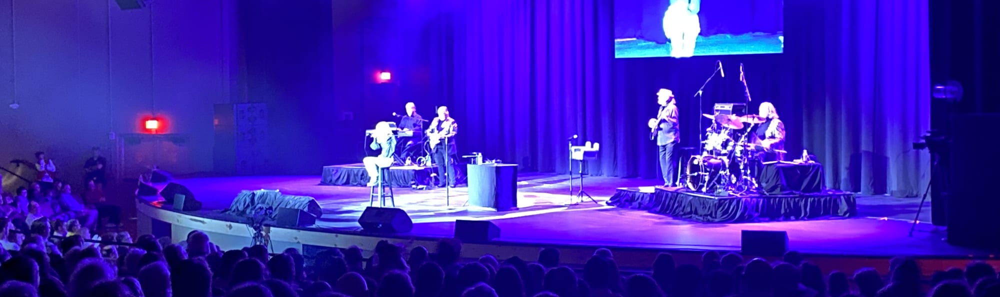 signer on stage in chair washed out by the lights Knoxville