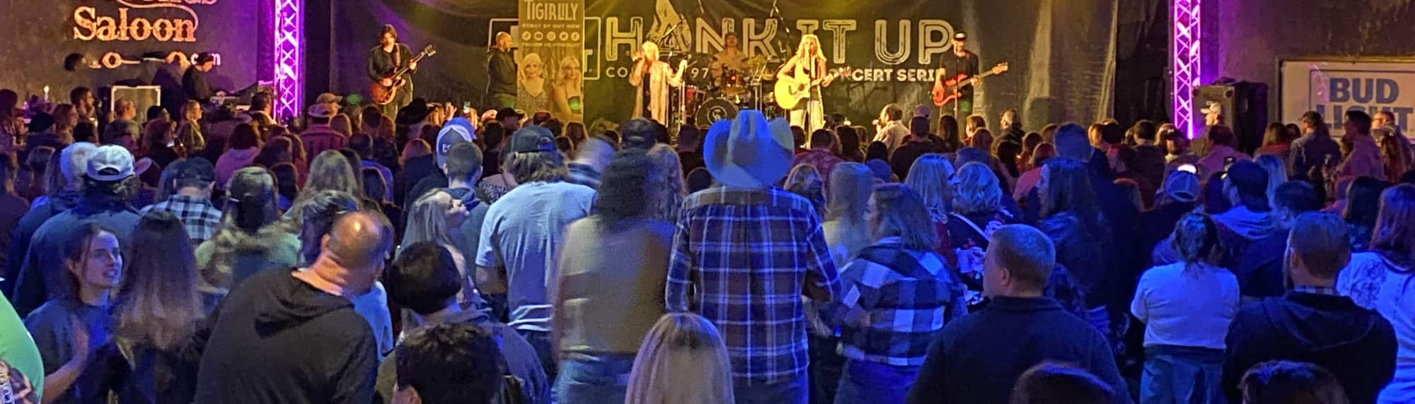 country concert with fans wearing cowboy hats Knoxville